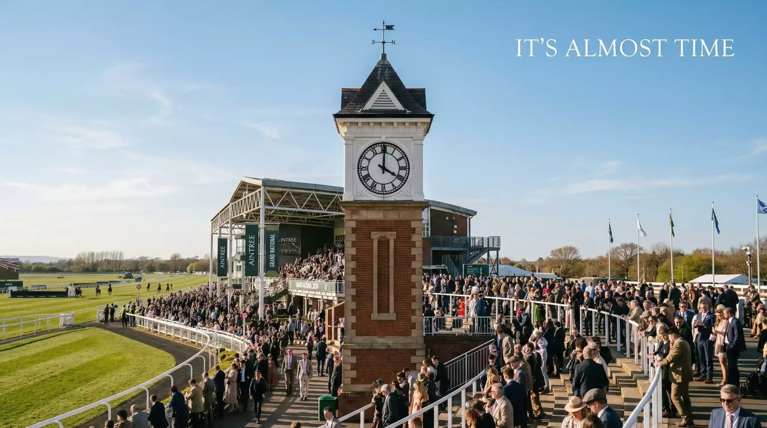 The Aintree racecourse clock tower showing 4pm on Grand National day